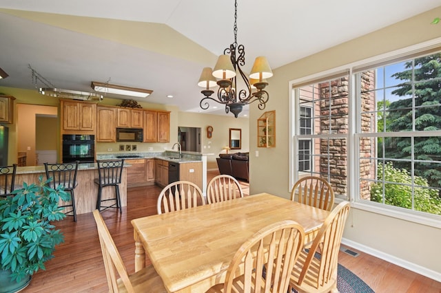 7770 Farrell Dr, Lakewood, IL 60014 - dining room featuring light wood-type flooring, vaulted ceiling, and a chandelier