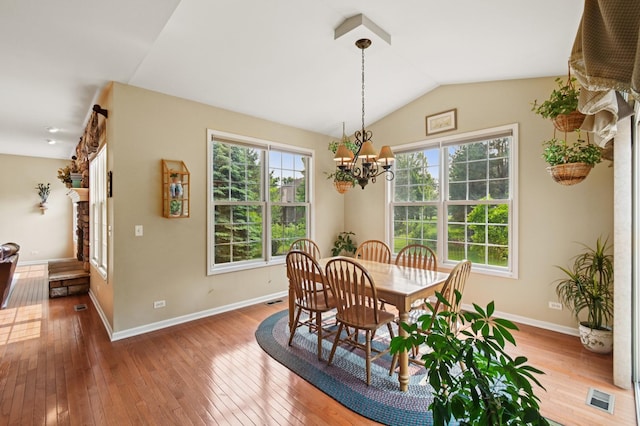 7770 Farrell Dr, Lakewood, IL 60014 - dining room featuring hardwood / wood-style floors, a chandelier, and lofted ceiling