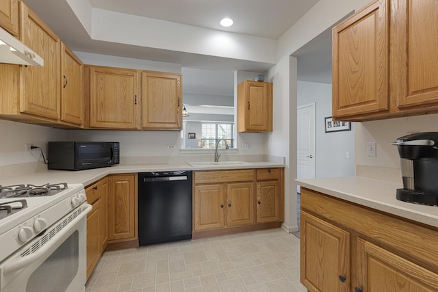 kitchen with black appliances, a sink, under cabinet range hood, light countertops, and recessed lighting