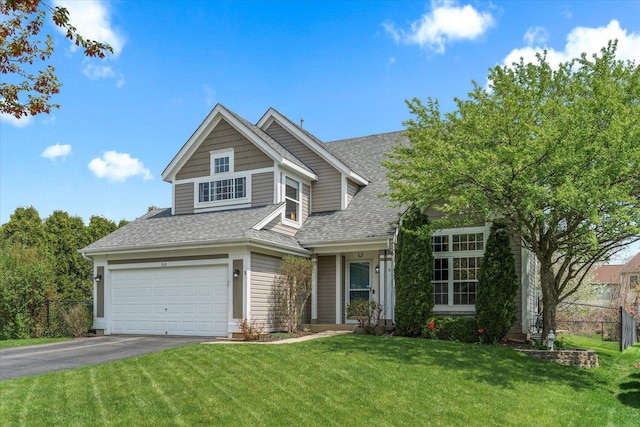 968 N Lancaster Cir S, Elgin, IL 60177 - traditional home featuring driveway, fence, a front lawn, an attached garage, and a shingled roof