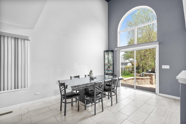 968 N Lancaster Cir S, Elgin, IL 60177 - dining area featuring a high ceiling, visible vents, and baseboards