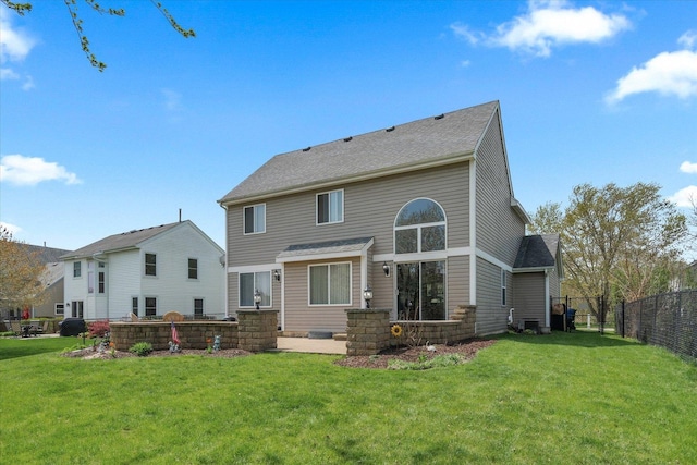 968 N Lancaster Cir S, Elgin, IL 60177 - rear view of house with fence, central air condition unit, a shingled roof, and a lawn