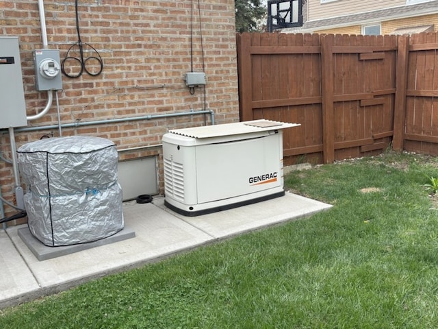 details with brick siding, a power unit, fence, and electric meter