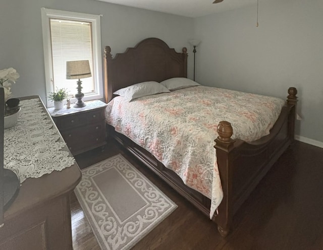 bedroom featuring a ceiling fan, baseboards, and wood finished floors