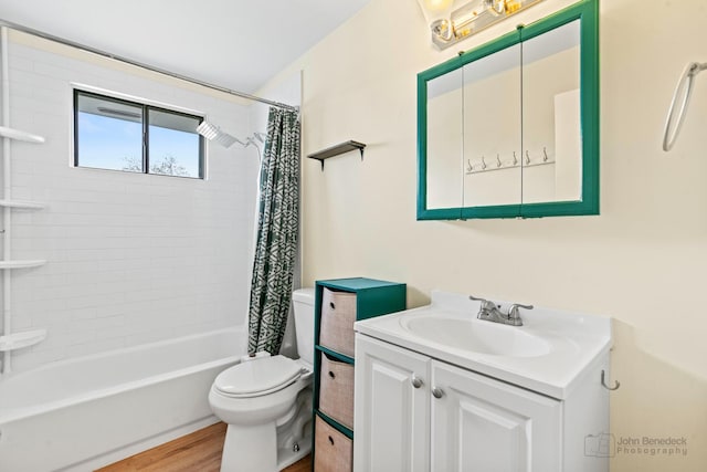 bathroom with toilet, shower / bath combination with curtain, wood finished floors, and vanity