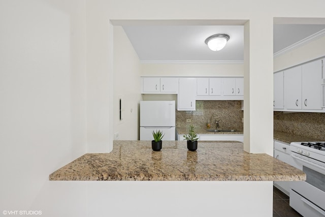 kitchen featuring white cabinetry, ornamental molding, white appliances, and tasteful backsplash
