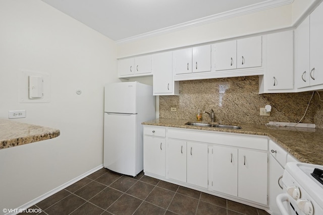 kitchen with a sink, freestanding refrigerator, range, decorative backsplash, and ornamental molding