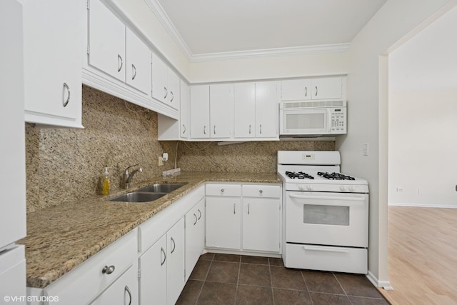 kitchen with ornamental molding, white appliances, a sink, backsplash, and white cabinets