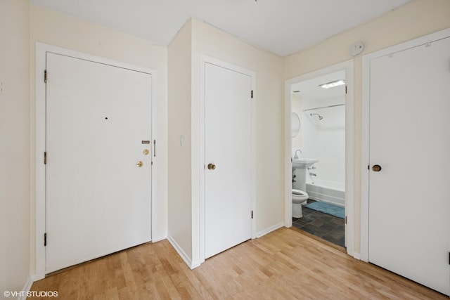 entrance foyer featuring light wood-style floors and baseboards