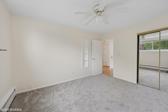 unfurnished bedroom featuring baseboards, baseboard heating, a closet, and carpet floors