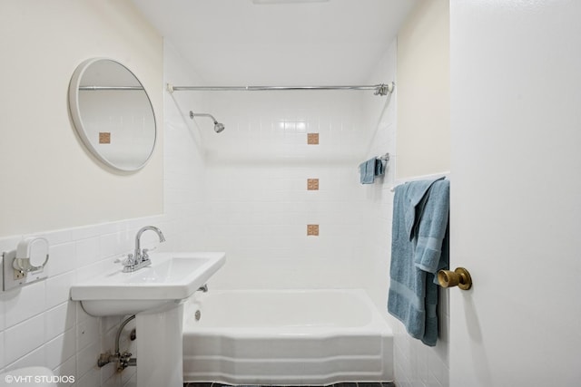 full bathroom with tile walls and shower / tub combination