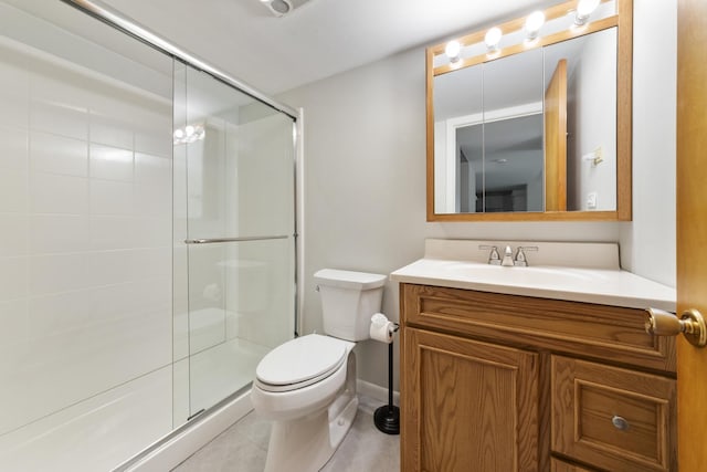 bathroom featuring toilet, a shower stall, tile patterned flooring, and vanity