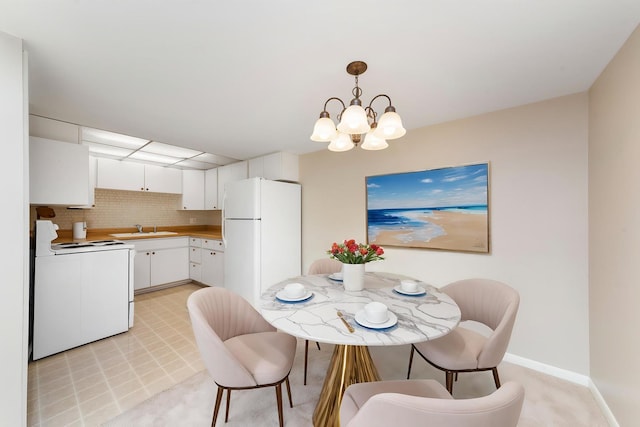 dining room with baseboards and a chandelier