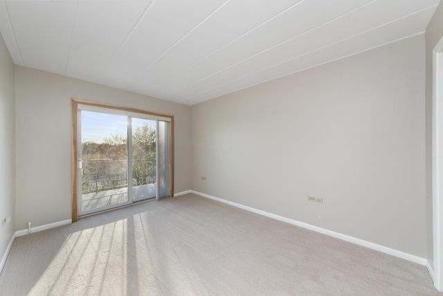 unfurnished room featuring light colored carpet and baseboards