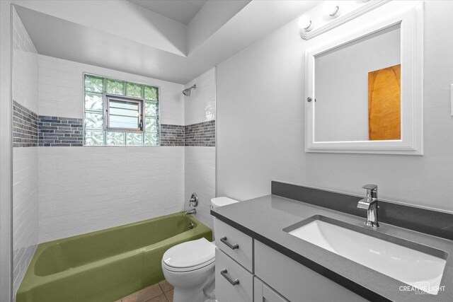 full bath with tile patterned flooring, toilet, washtub / shower combination, and vanity