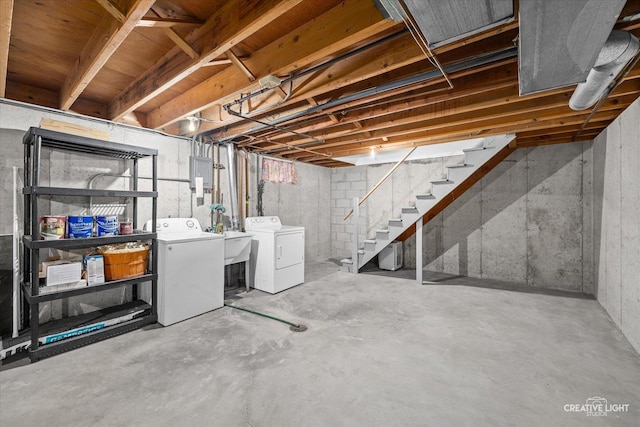 unfinished basement featuring separate washer and dryer and stairs