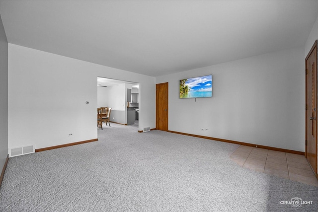 empty room featuring carpet floors, baseboards, and visible vents
