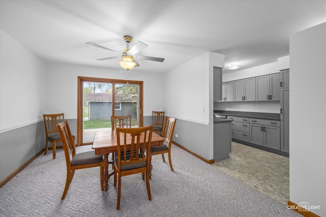 dining area with baseboards and ceiling fan