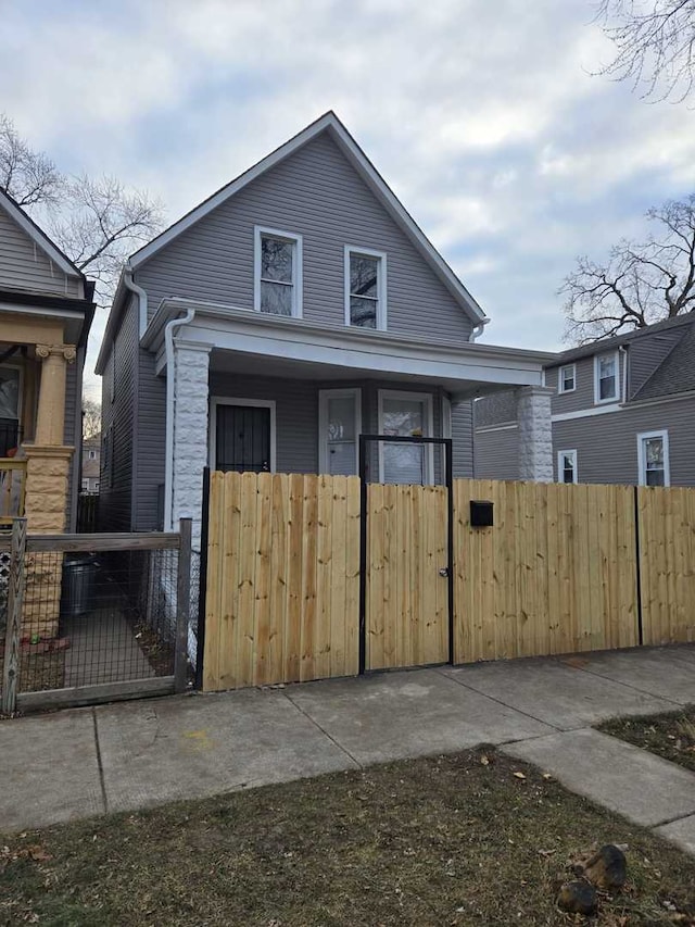 view of front facade with fence private yard and a gate