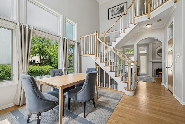 874 W Goodrich Pl, Palatine, IL 60067 - dining room with a towering ceiling, arched walkways, baseboards, stairway, and wood finished floors