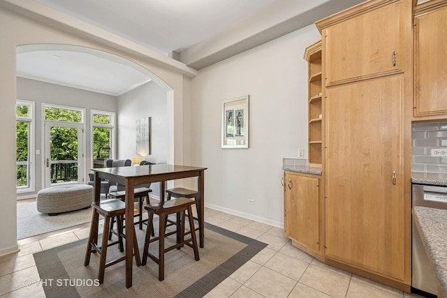 874 W Goodrich Pl, Palatine, IL 60067 - dining area featuring arched walkways, light tile patterned flooring, and baseboards