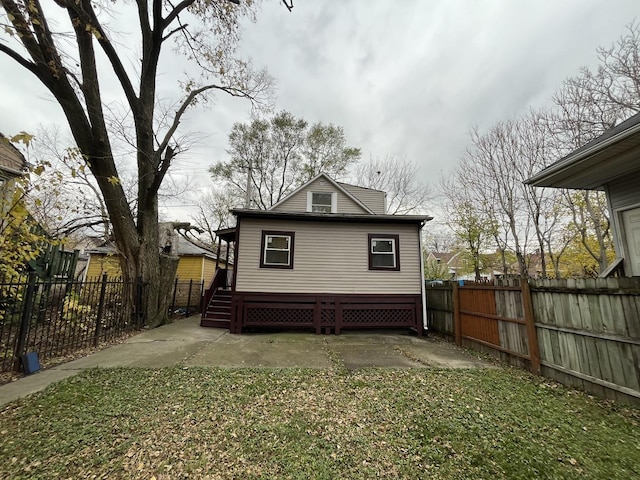 back of house featuring fence private yard and a patio area