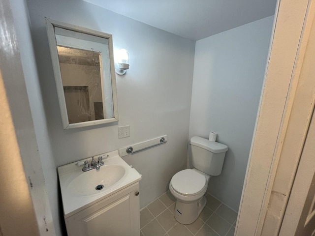 bathroom featuring vanity, tile patterned floors, and toilet