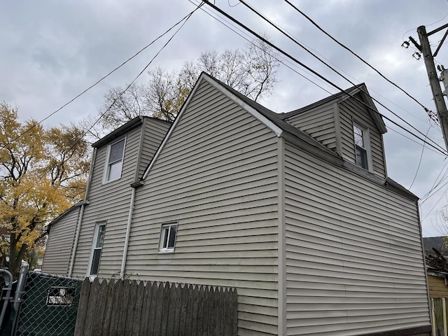 view of property exterior featuring fence