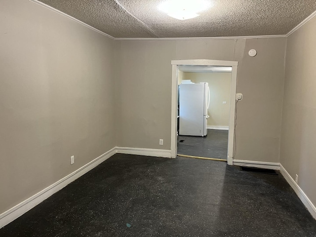 unfurnished room featuring baseboards, ornamental molding, and a textured ceiling