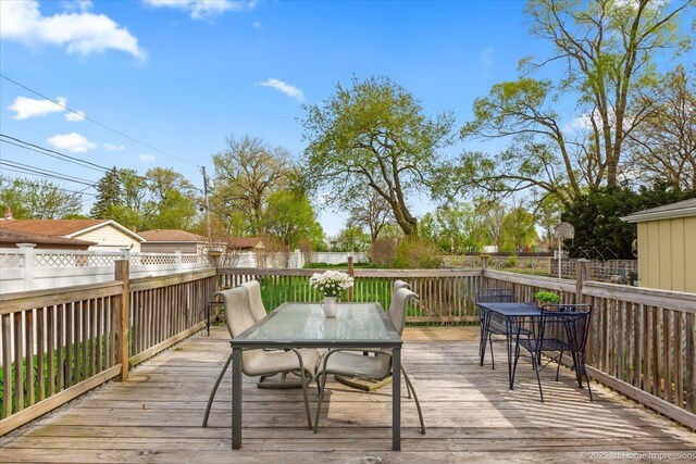 deck featuring outdoor dining area