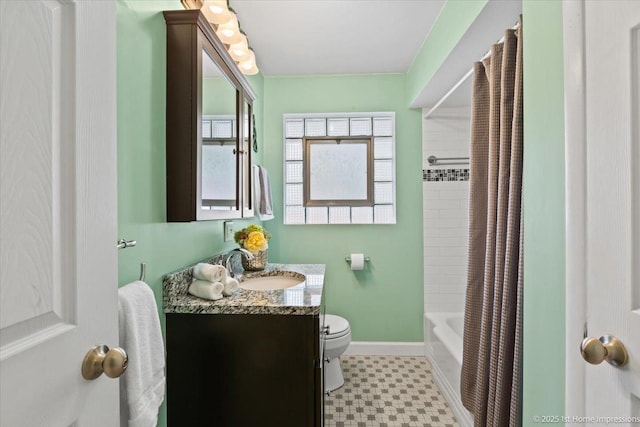 bathroom featuring shower / bath combo, tile patterned floors, baseboards, vanity, and toilet