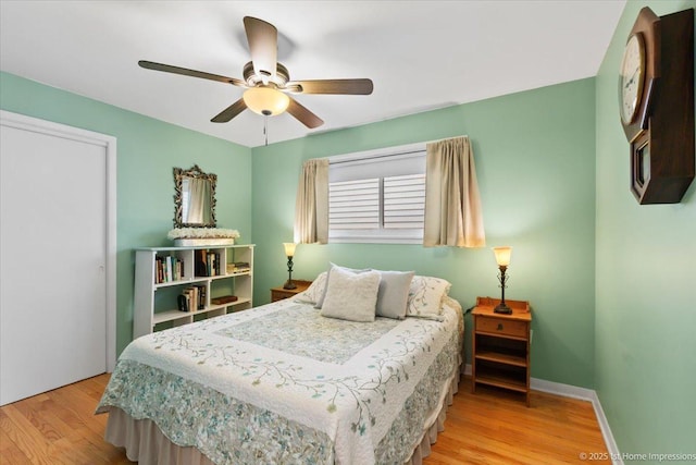 bedroom featuring baseboards, ceiling fan, and wood finished floors