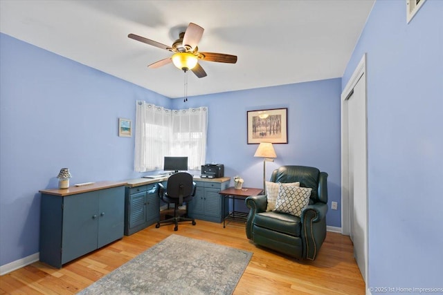 home office featuring ceiling fan, baseboards, and light wood finished floors