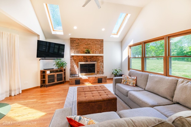 1 Byron Ct, Hawthorn Woods, IL 60047 - living area with a skylight, high vaulted ceiling, light wood-style flooring, a fireplace, and a ceiling fan