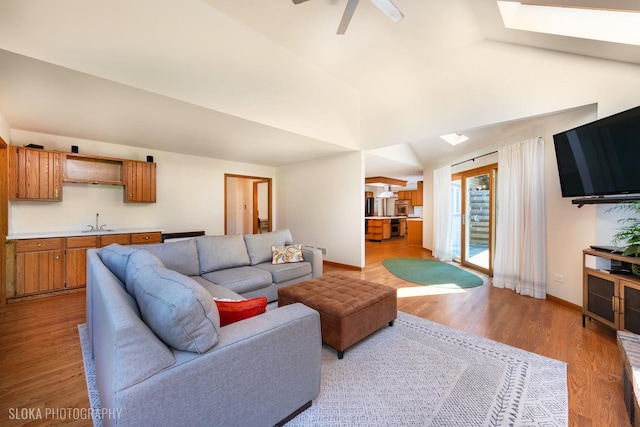 1 Byron Ct, Hawthorn Woods, IL 60047 - living room featuring light wood-style flooring, baseboards, a ceiling fan, a skylight, and lofted ceiling