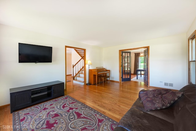1 Byron Ct, Hawthorn Woods, IL 60047 - living area with light wood finished floors, stairway, french doors, and baseboards