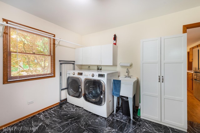 1 Byron Ct, Hawthorn Woods, IL 60047 - laundry area with dark marble finish floors, cabinet space, separate washer and dryer, and baseboards
