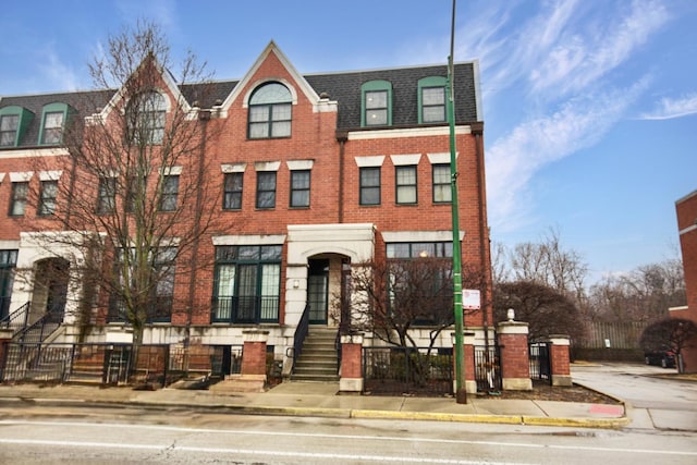 5912 N NW Hwy, Chicago, IL 60631 - townhome / multi-family property with brick siding, a shingled roof, and mansard roof