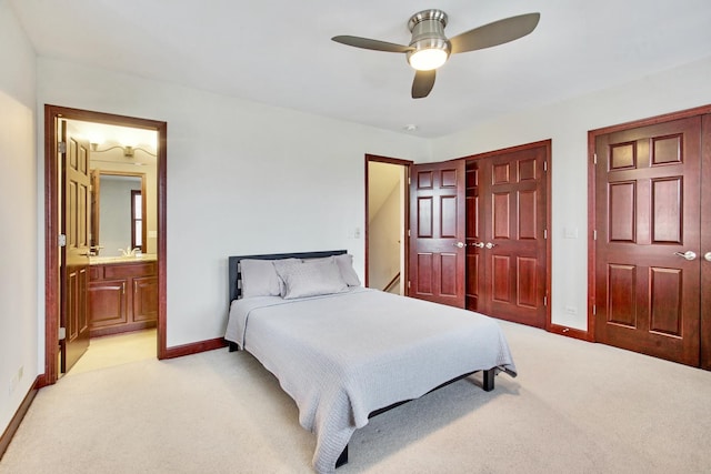 5912 N NW Hwy, Chicago, IL 60631 - bedroom with light colored carpet, baseboards, ensuite bath, and a ceiling fan