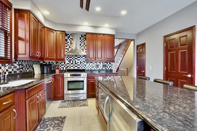 5912 N NW Hwy, Chicago, IL 60631 - kitchen featuring stainless steel appliances, wall chimney range hood, a sink, tasteful backsplash, and dark stone counters