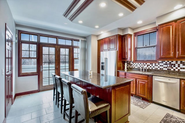 5912 N NW Hwy, Chicago, IL 60631 - kitchen with stainless steel appliances, a sink, a kitchen breakfast bar, tasteful backsplash, and a kitchen island