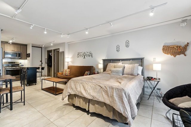 bedroom with track lighting and light tile patterned floors