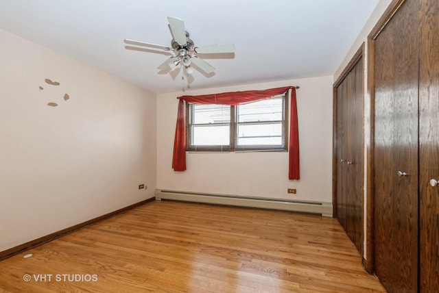 6004 S Kolmar Ave, Chicago, IL 60629 - unfurnished bedroom featuring a closet, baseboards, a baseboard heating unit, and light wood-style flooring
