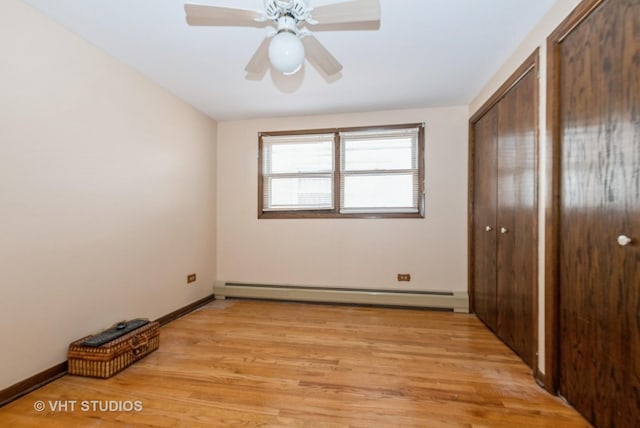 6004 S Kolmar Ave, Chicago, IL 60629 - unfurnished bedroom with ceiling fan, baseboard heating, baseboards, a closet, and light wood-style floors