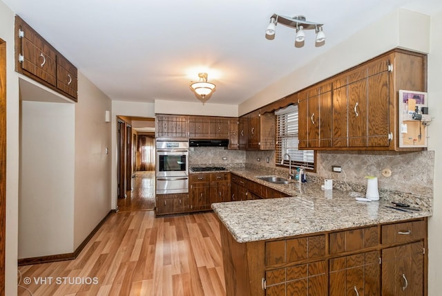 6004 S Kolmar Ave, Chicago, IL 60629 - kitchen featuring appliances with stainless steel finishes, a sink, light wood finished floors, tasteful backsplash, and a warming drawer
