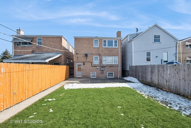 6004 S Kolmar Ave, Chicago, IL 60629 - rear view of property featuring a lawn, a fenced backyard, a patio area, and brick siding