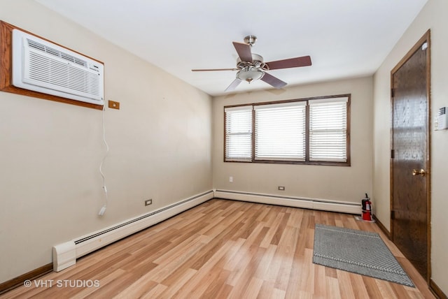 6004 S Kolmar Ave, Chicago, IL 60629 - spare room featuring an AC wall unit, a ceiling fan, baseboard heating, and light wood-style flooring
