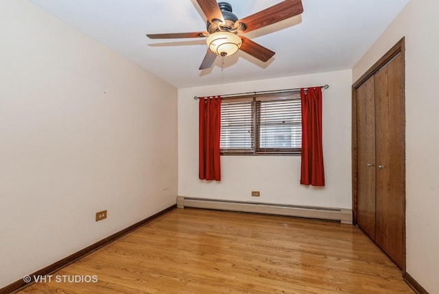 6004 S Kolmar Ave, Chicago, IL 60629 - unfurnished bedroom featuring light wood-style floors, a baseboard heating unit, baseboards, and a closet