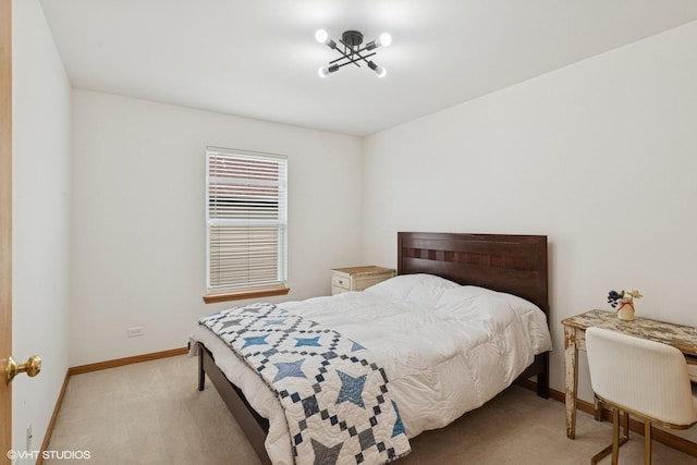 bedroom with baseboards and light carpet