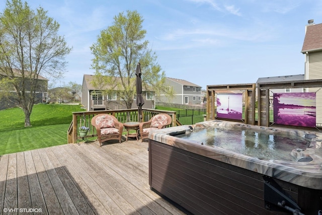 wooden deck featuring a hot tub, a yard, fence, and a residential view